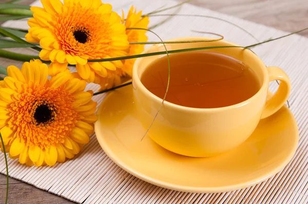 Tea with cake and gerberas flowers — Stock Photo, Image