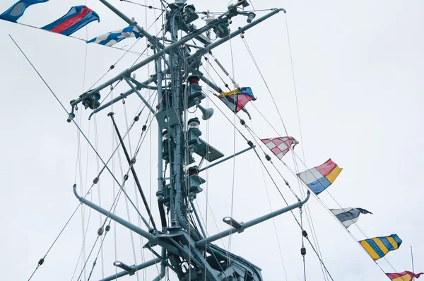 Mast of the military ship and alarm flags — Stock Photo, Image