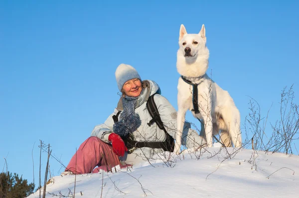 有一只狗在冬天在步行中的女人 — 图库照片