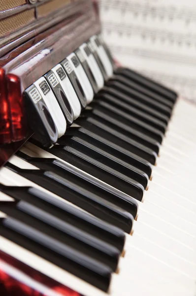 Red accordion and sheet music, close up — Stock Photo, Image