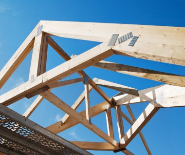 Wooden rafters against the blue sky clipart