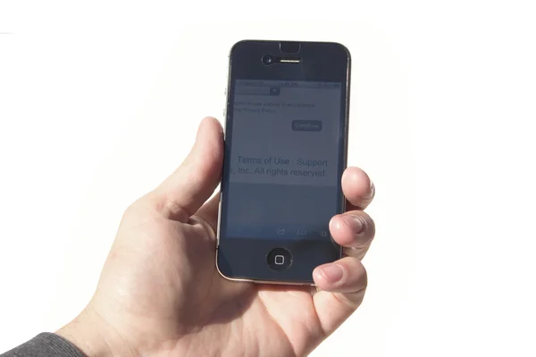 Mano izquierda sosteniendo un iPhone 4S Imagen de archivo