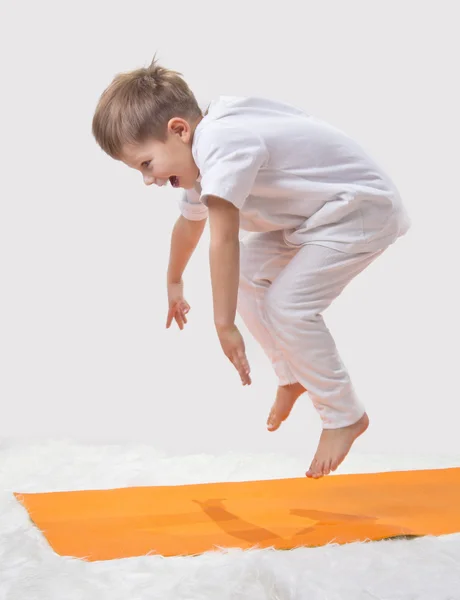 Kid jumps, doing yoga — Stock Photo, Image