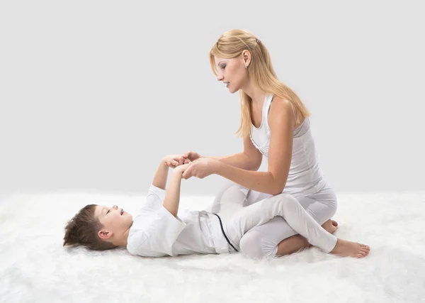 Mor och son gör yoga innan sängen — Stockfoto