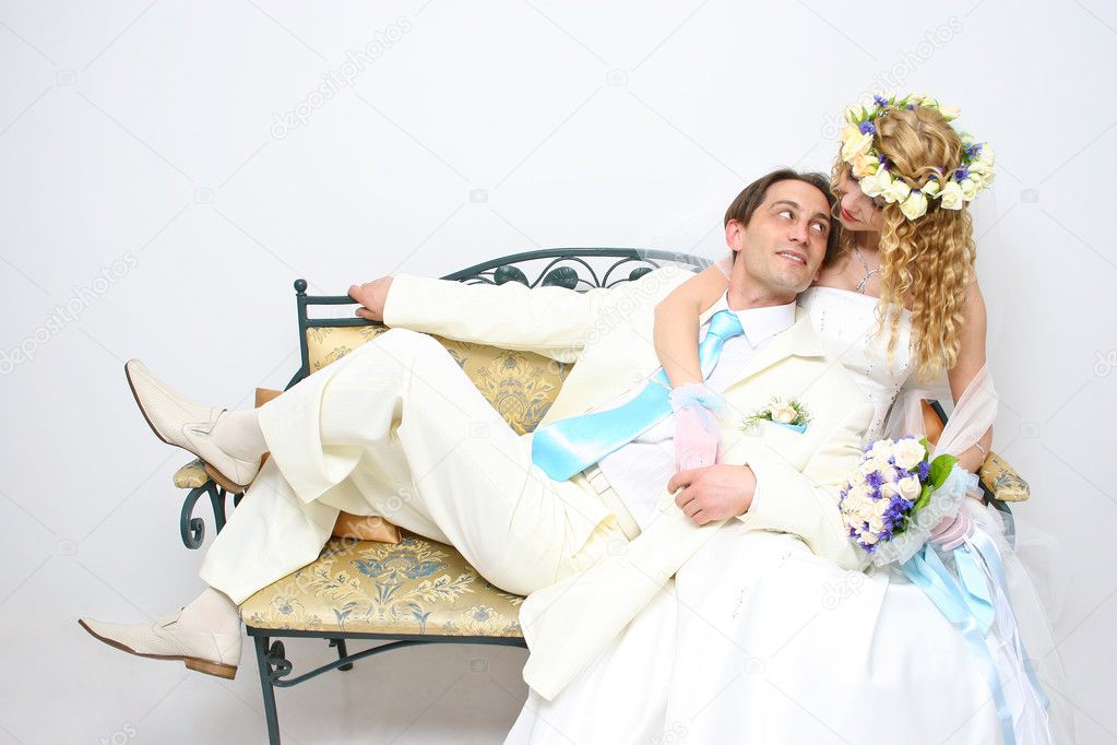 Young couple posing in a studio on the wedding day