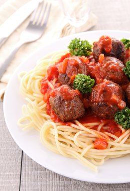 Spaghetti and tomato sauce with meatballs clipart