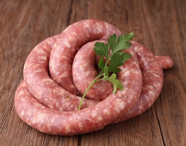 Raw sausage and parsley clipart