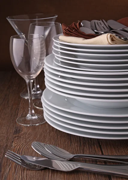 Plate pile,glasses and cutlery — Stock Photo, Image