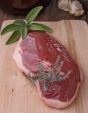 Raw duck meat with herbs clipart