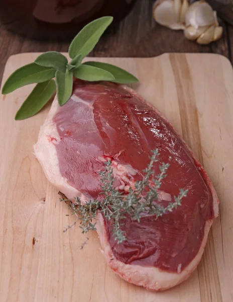 stock image Raw duck meat with herbs