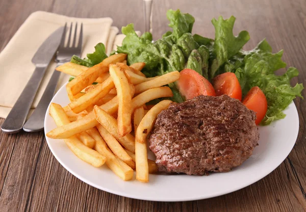 Grilled steak, french fries and vegetables — Stock Photo, Image