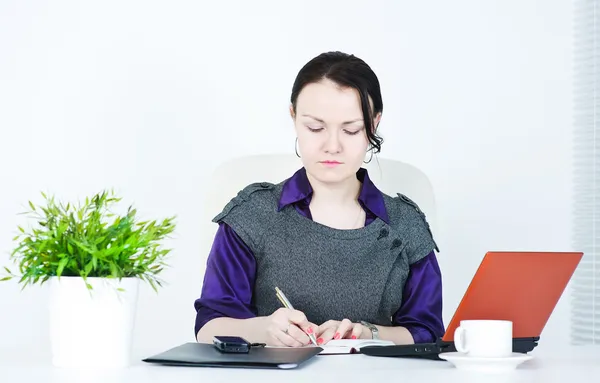 Serious business woman writing — Stock Photo, Image