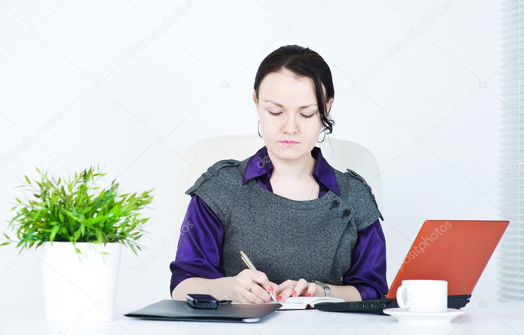 Serious business woman writing