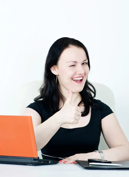 Business woman winking and showing thumbs up — Stock Photo, Image