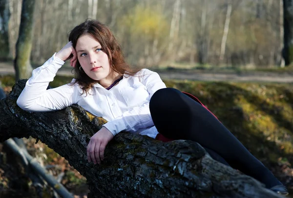 Jeune femme allongée sur l'arbre — Photo