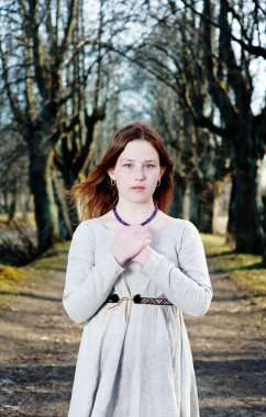 Young woman in vintage dress pray clipart