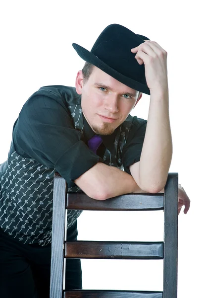 Man in black hat with chair — Stock Photo, Image