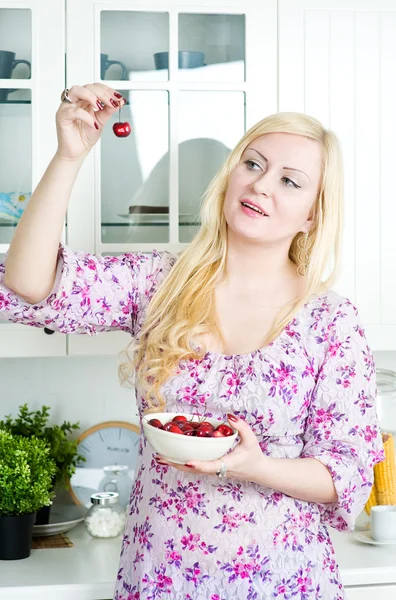 Mulher loira comendo cereja — Fotografia de Stock