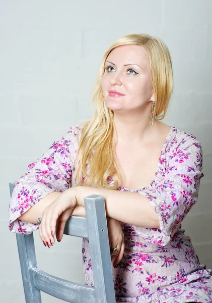 Blond woman sitting on the chair — Stock Photo, Image