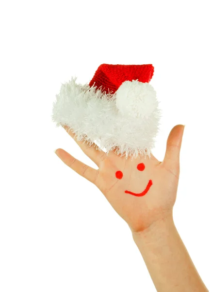 Palma de humano com sorriso sobre ele usando chapéu de Papai Noel — Fotografia de Stock