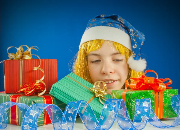 Здивована дівчина-підліток дивиться з-за різдвяних подарунків — стокове фото