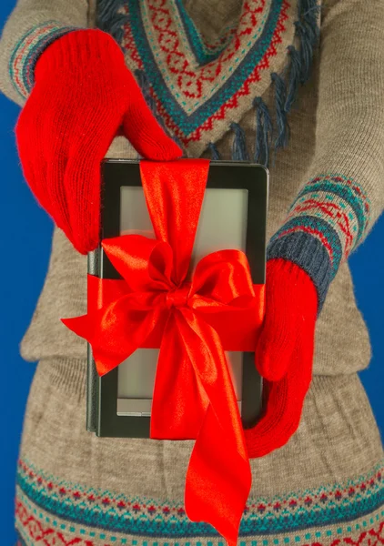 Девушка держит электронный читатель книг в красных перчатках — стоковое фото