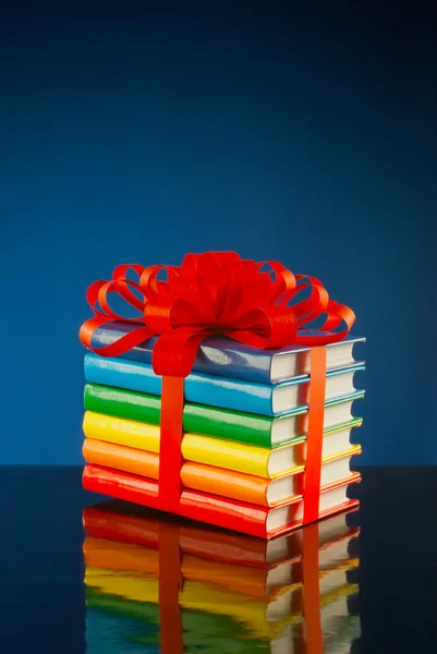 Montón de libros de colores atados con cinta roja —  Fotos de Stock