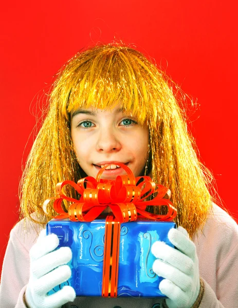 Teen girl with a present against red background — Stock Photo, Image