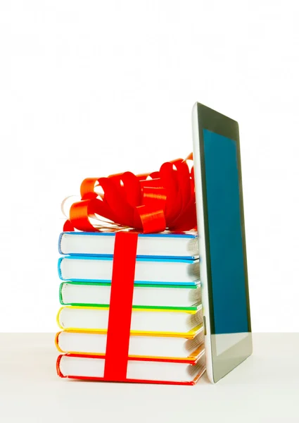 Books tied up with ribbon and tablet PC against white background — Stock Photo, Image