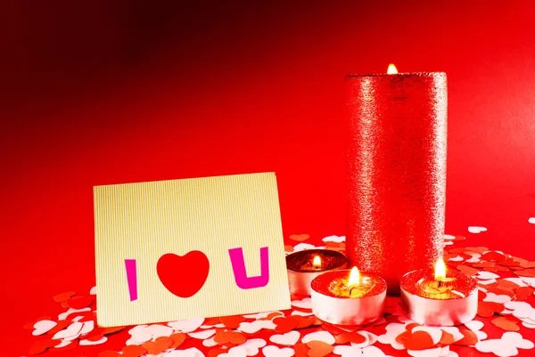 Día de San Valentín saludo fondo con cuatro velas encendidas —  Fotos de Stock