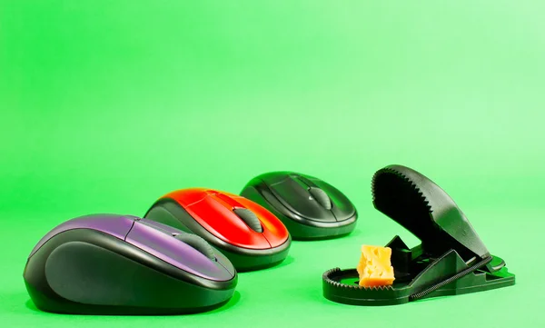 Three computer mouses with a mousetrap