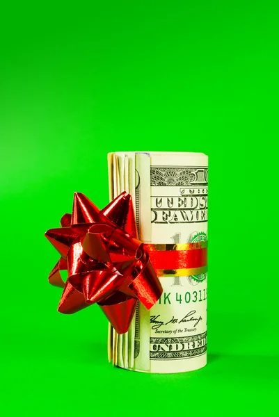 A wad of US one hundred dollar bills tied up with red ribbon — Stock Photo, Image