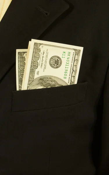 Närbild av affärsman med dollar sedlar i ficka — Stockfoto