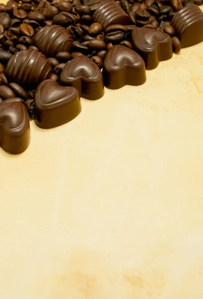 Heart shaped chocolate candies and coffee beans — Stock Photo, Image