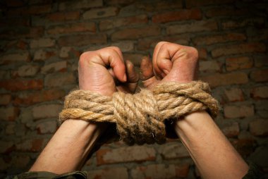 Hands of man tied up with rope clipart