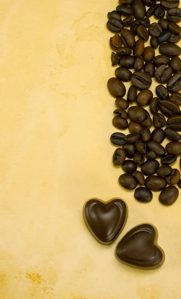 stock image Two heart shaped chocolate candies and coffee beans