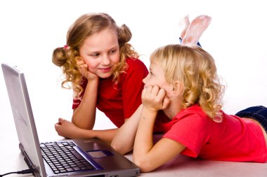 Kids playing computer game on laptop clipart