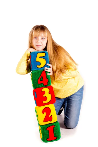 Chica feliz sosteniendo bloques con números — Foto de Stock