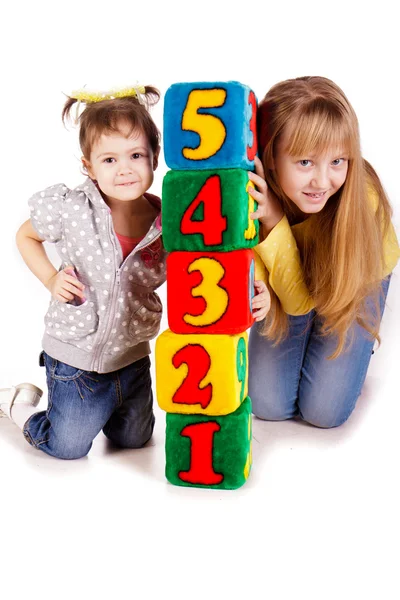 Happy kids holding blocks with numbers — Stock Photo, Image