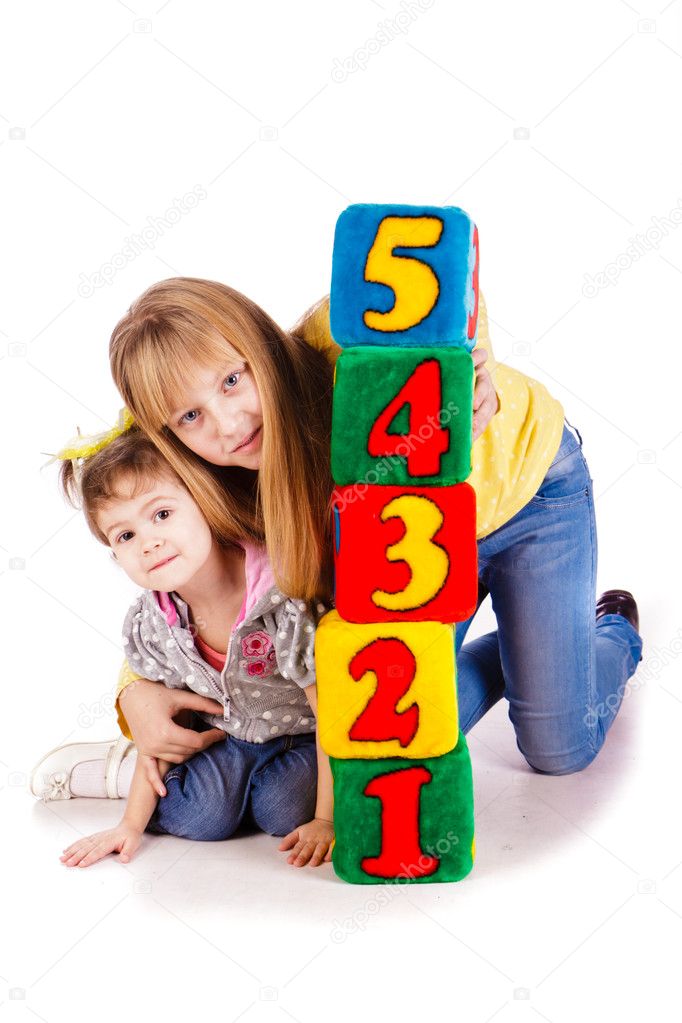Happy kids holding blocks with numbers