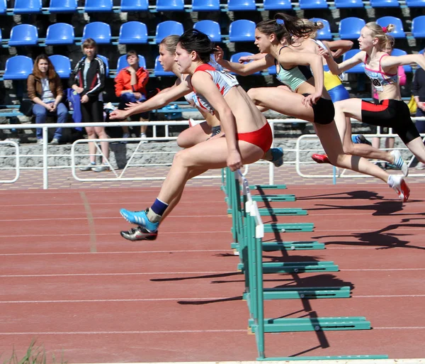 Girls on the 100 meters hurdles race — Stock Photo, Image