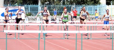 Girls on the 100 meters hurdles race clipart