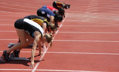 Girls on the start of the 100 meters dash clipart