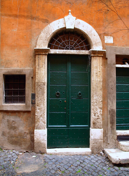 Exterior of the typical old door in Rome, Italy.