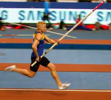 DONETSK, UKRAINE - FEB.11: Denys Yurchenko on the Samsung Pole Vault Stars meeting on February 11, 2012 in Donetsk, Ukraine. He won bronze medal in the pole vault event at Summer Olympics in Beijing. clipart