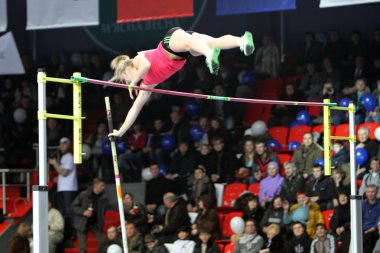 DONETSK, UKRAINE - FEB.11: Anna Shleh wins women's competition with Ukrainian National Record and the result 5.60 on Samsung Pole Vault Stars meeting on February 11, 2012 in Donetsk, Ukraine. clipart