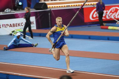 DONETSK, UKRAINE - FEB.11: Denys Yurchenko on the Samsung Pole Vault Stars meeting on February 11, 2012 in Donetsk, Ukraine. He won bronze medal in the pole vault event at Summer Olympics in Beijing. clipart