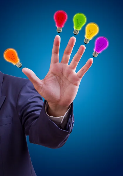 Colorful bulb on fingers — Stock Photo, Image