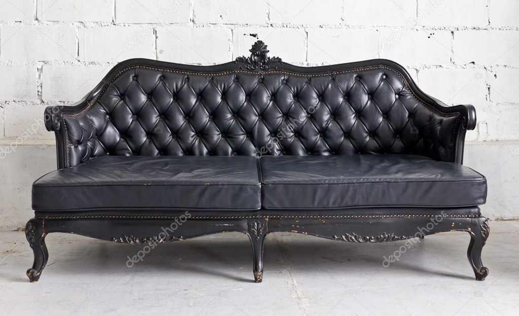 Black vintage armchair in white room