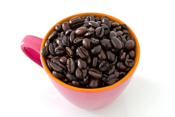 Coffee beans in pink cup — Stock Photo, Image